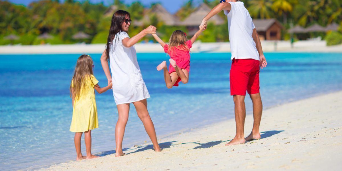 Happy beautiful family on a beach during summer vacation